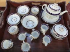An early 19th Century part tea service. Moulded swirl form with blue bands and gilt decoration