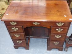 An 18th.c.mahogany kneehole writing desk with arrangement of drawers and central cupboard