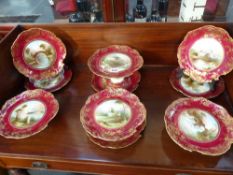 An Aynsley dessert service with Irish landscape decoration, cranberry red borders with elaborate