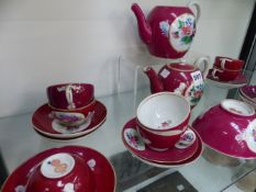 An Antique Russian porcelain part tea service, claret red with floral panels