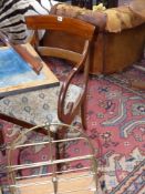 A late Regency mahogany armchair together with an Edwardian oak and brass magazine stand and an