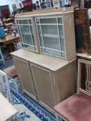An antique painted side cabinet with two door glazed upper section