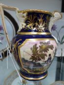 An early 19th Century pitcher decorated with anglers and hunter. Cobalt blue with gilt accents