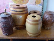 Three stoneware pottery spirit barrels with relief decoration and two others