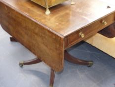 A late Georgian mahogany and ebony strung pedestal Pembroke table