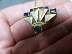 An Art Deco style pendant set with sapphires. Stamped Lalique. Set in a yellow precious mount