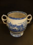 A 19th Century blue and white printed pottery two handled baluster pot. Decorated with an Eastern