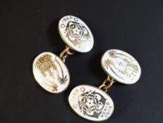 A pair of 9ct gold white enamelled cuff links. From the World Tour of 1959 H.M.S. Brittania