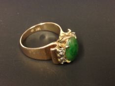 A 14ct diamond and jade set dress ring