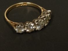 An 18ct gold and platinum set five stone diamond ring