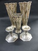 A pair of Persian silver coloured tapered segmental vases. 22cm high. Another smaller 15cm and a