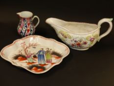 A Bow type spoon tray with chinoiserie scene. A Derby sauce boat and a Worcester whorl pattern cream