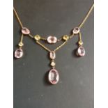 An art Nouveau amethyst and peridot necklace set single diamond