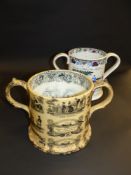 A 19th Century Staffordshire printed two handled loving cup. Decorated with a monochrome generic