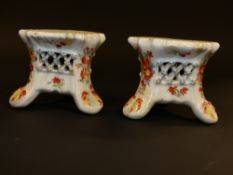 A pair of Bow tripart pedestals. With pierced latticed border. Painted with summer flowers. 6cm