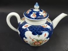 A Dr Wall Period Worcester teapot. With blue scale ground decorated with Kakiemon style panels. 15cm