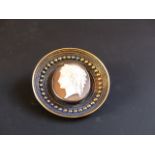 A late 19th Century cameo set yellow precious metal brooch. With locket aperture to reverse