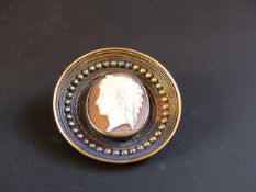 A late 19th Century cameo set yellow precious metal brooch. With locket aperture to reverse