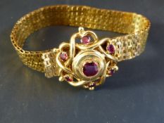 A late 19th Century gold coloured precious metal bracelet set with gem stones