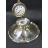 A gentleman's silver desk top capstan inkwell. The lid incorporating a timepiece. dates Birmingham