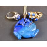 A carved Lupis Lazuli pendant on chain. A Lupis Lazuli 9ct gold dress ring and a 14k blue stone