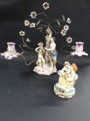 A late 19th Century Meissen figure group of a lady seated feeding her pet cat. 13cm high. Together