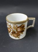 A Meissen coffee can. Painted with tulips in brown and gilt enamels. Gilded edging. 7cm high
