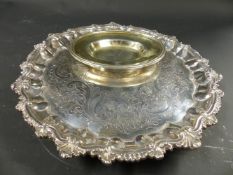 A George IV silver salver. With embossed scallop rim. London 1828. 21ozs. 26cm diameter. Together