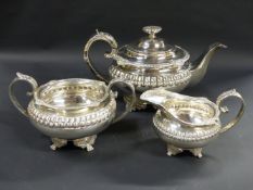 A silver three piece tea set. With moulded border and embossed rims. Sheffield 1821 and 1923. 44ozs