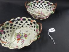 A pair of early 19th Century porcelain two handled chestnut baskets. With interlaced border. The