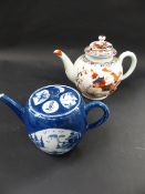 An early Worcester style porcelain teapot. Painted with blue and russett scenes of dwellings and