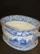A 19th Century blue and white printed pottery footbath. Decorated with an English landscape to