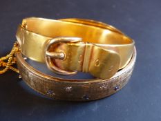 A yellow precious metal stiff buckle bracelet. 15grams. A 9ct gold wax filled stiff bracelet set
