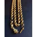 A mid-19th Century gold coloured precious metal fancy link long guard chain. With granulated