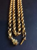 A mid-19th Century gold coloured precious metal fancy link long guard chain. With granulated