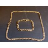 A 9ct gold chain. 10grms. Together with a yellow precious metal bracelet stamped 18ct. 11grams