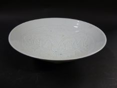A Chinese pale celadon glazed shallow bowl. With foliate designs to interior. 19cm diameter. 7cm