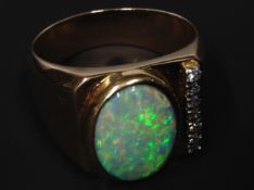 An opal and diamond set cocktail ring. Stamped 18ct. 26grms
