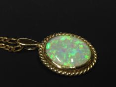 A 9ct gold oval opal pendant on chain