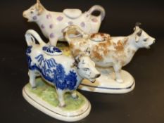 Three Staffordshire cow creamers. On oval bases