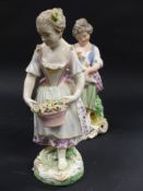 A Derby figurine of a young girl holding her pet lamb. 17cm high. Together with another figurine