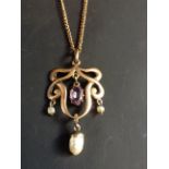 An Art Nouveau openwork pendant. Set with amethyst drop and freshwater pearl drops