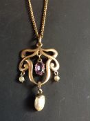 An Art Nouveau openwork pendant. Set with amethyst drop and freshwater pearl drops