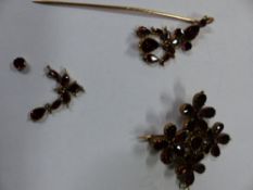 A 19th Century flat cut garnet cruciform pendant/brooch. A similar pendant suspended from a pin (2)