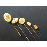 A 9ct gold butterfly stick pin and four others