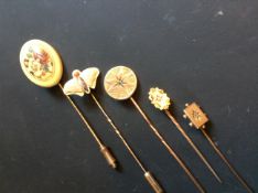 A 9ct gold butterfly stick pin and four others