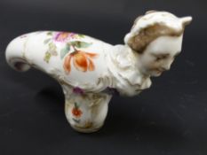 A 19th Century porcelain cane handle. With woman's head finial. Painted with lilly and tulip