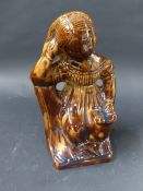 An early 19th Century mottled brown glazed figure. Depicting a woman reading a Holy Bible. 20cm