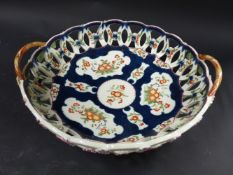 A Worcester two handled chestnut basket. With dark blue scale centre field. Embellished with