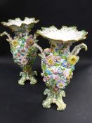 A pair of Coalbrookdale style porcelain two handled vases. 29cm high